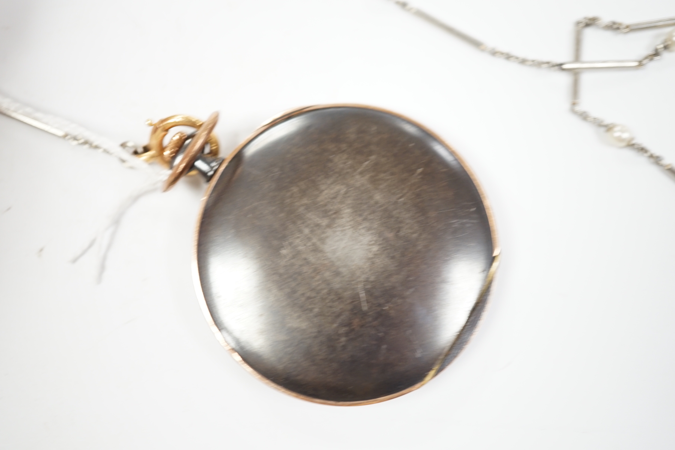 A gun metal and yellow metal dress pocket watch, on a white metal and seed pearl set chain, with lapis lazuli set fob.